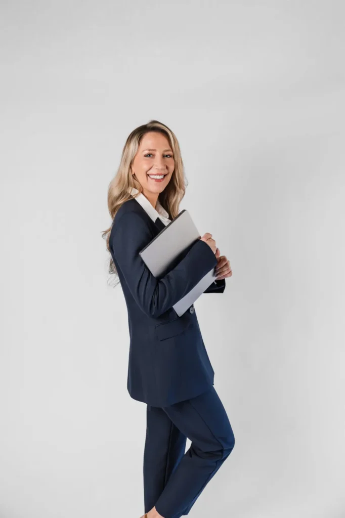 Maya Cakar, founder of Grow Social Media, holding a laptop